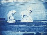 two statues that are sitting on a ledge