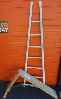 a ladder leaning up against a wall next to a sign
