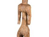 a wooden statue of a man with a hat on his head
