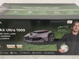 the box of a lawn mower with a man holding a soccer ball