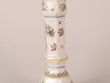 a close up of a vase on a white surface