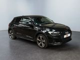 a black audi suv parked in an empty room