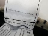 a person holding a label on a piece of clothing