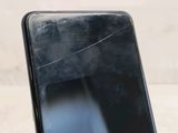a close up of a cell phone with a broken screen