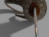 a silver spoon with a handle on a gray surface