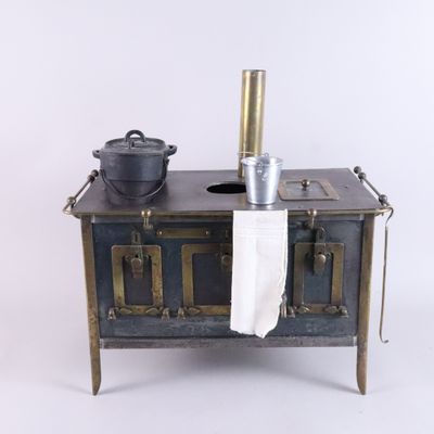 a small stove with a pot on top of it