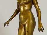 a bronze statue of a woman standing on a marble base