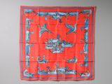 a red and blue scarf hanging on a wall