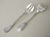 two spoons and a fork on a table