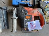 a cordless drill, a hammer, a cell phone, and a cell phone on the floor