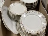a lot of plates in a box on the floor
