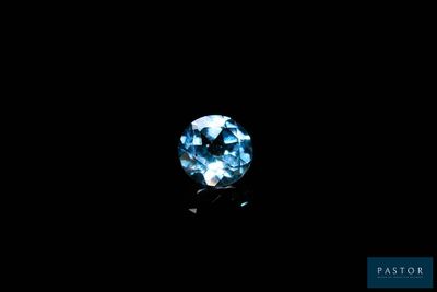 a close up of a blue diamond on a black background