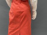 a woman ' s white blouse and orange skirt on a mannequin mannequin mannequin mann