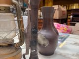 a lamp that is sitting on a table next to a vase
