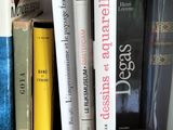 many books that are on a shelf in the room