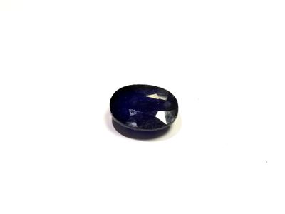 a close up of a blue sapphire stone on a white surface