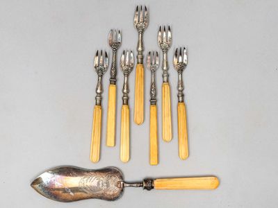 cinq fourchettes, une cuillère et un repose-cuillère posés sur une table
