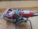 a red machine that is sitting on the ground