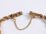 an image of a gold bracelet with a chain and a clasp