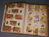 an open book with pictures of people and animals on it
