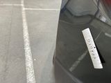 a parking meter on the side of the road with a sticker on it