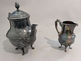 pair of antique silver plated teapots and saucer on stand