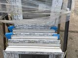 a stack of windows that have been wrapped in plastic