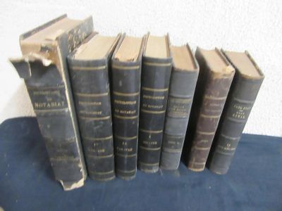 several old books are lined up on a blue cloth