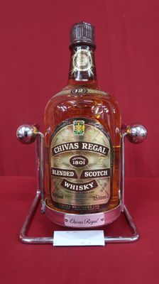 bottle of chivas regal blended scotch whisky on display on red background