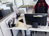 a desk with a chair and a computer on it