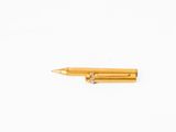 yellow metal pen on a white surface with a white background