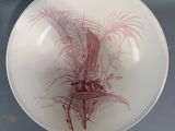 a bowl with a plant in it on a glass table
