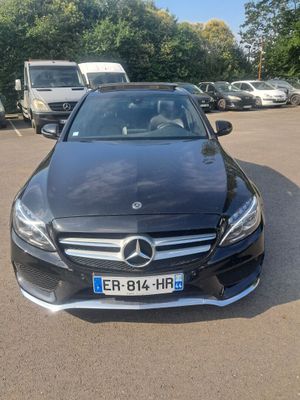 a black mercedes s - class is parked in a parking lot