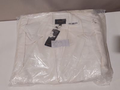 a white t - shirt wrapped in plastic on a table