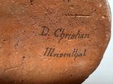 a close up of a brown shoe with writing on it