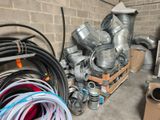 many different types of pipes and hoses in a room