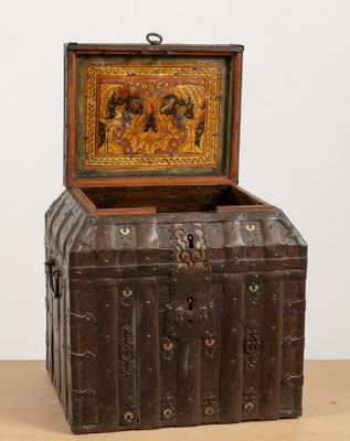 an old wooden chest with a painting on it sitting on top of a table