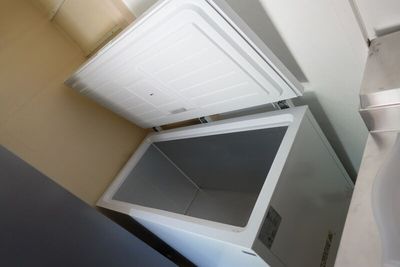 an image of a small white refrigerator in a kitchen