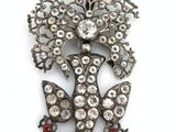 an image of a brooch with a bunch of flowers on it