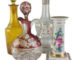 a group of glass vases and a plate on a table