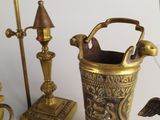 a lot of brass items that are on the table