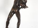 an image of a bronze statue of a man holding a tennis racquet