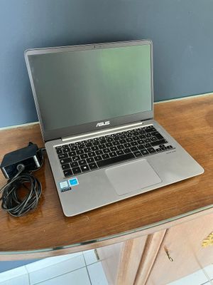 a laptop computer sitting on top of a wooden desk