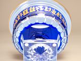 a glass bowl with a blue and gold design on it