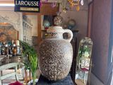 a large vase sitting on top of a table in a room
