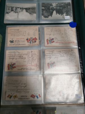 a lot of old postcards on display in a glass case