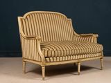 an image of a striped upholstered chair against a dark blue wall