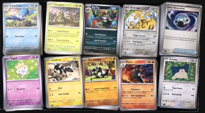 a lot of pokemon cards that are on the table