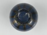 a close up of a blue glass bowl on a white surface