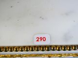an image of a white and gold plate with a red number on it